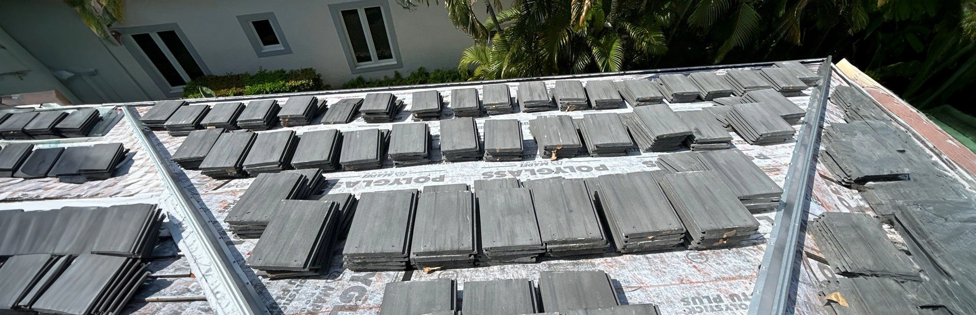 stacks of roof tiles for a new roof installation